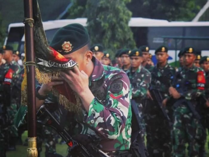 Prajurit Yonif Raider 321 Kostrad melaksanakan tradisi penciuman bendera sebelum berangkat bertugas ke Papua, Sabtu (04/06/2022) | Source: tni.mil.id